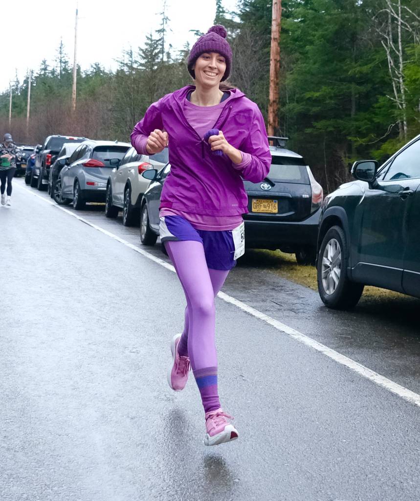 Christy Gentemann, running as rainbow color purple, wins the 5k at the Halloween Half Marathon and 5K on Saturday along North Douglas Highway. (Klas Stolpe / Juneau Empire)