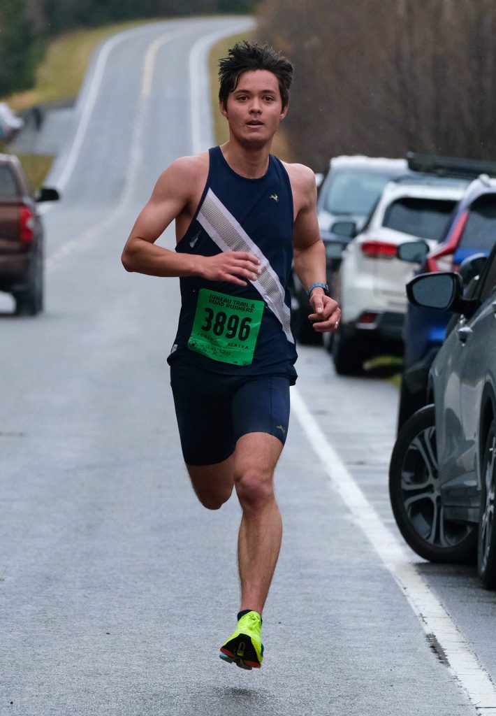 Petersburgs Uriah Lucas, 20, wins the Halloween Half Marathon in 1:16:05 on Saturday along North Douglas Highway. (Klas Stolpe / Juneau Empire)