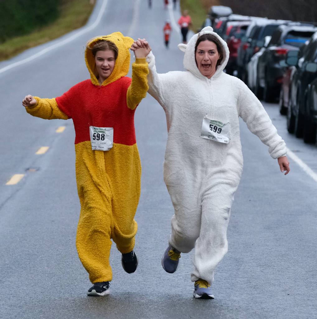 Paislee Shane and mother Jennifer Shane finish the Halloween Half Marathon and 5K on Saturday along North Douglas Highway. (Klas Stolpe / Juneau Empire)