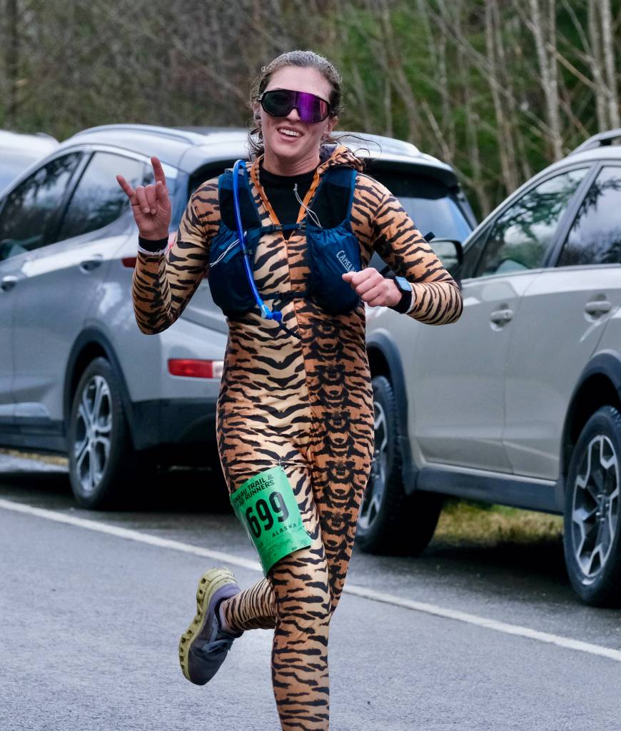 Kristen Strom finishes the Halloween Half Marathon and 5K on Saturday along North Douglas Highway. (Klas Stolpe / Juneau Empire)
