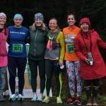 Members of the Rainbow Runners (not pictured is purple Christy Gentemann), from left, pink Jaqueline Stabbert, blue Hannah Bailey, green Kristin McTague, yellow Heather Parker, orange Danielle Dunivin and red Holly Handler at the Halloween Half Marathon and 5K on Saturday along North Douglas Highway. (Klas Stolpe / Juneau Empire)