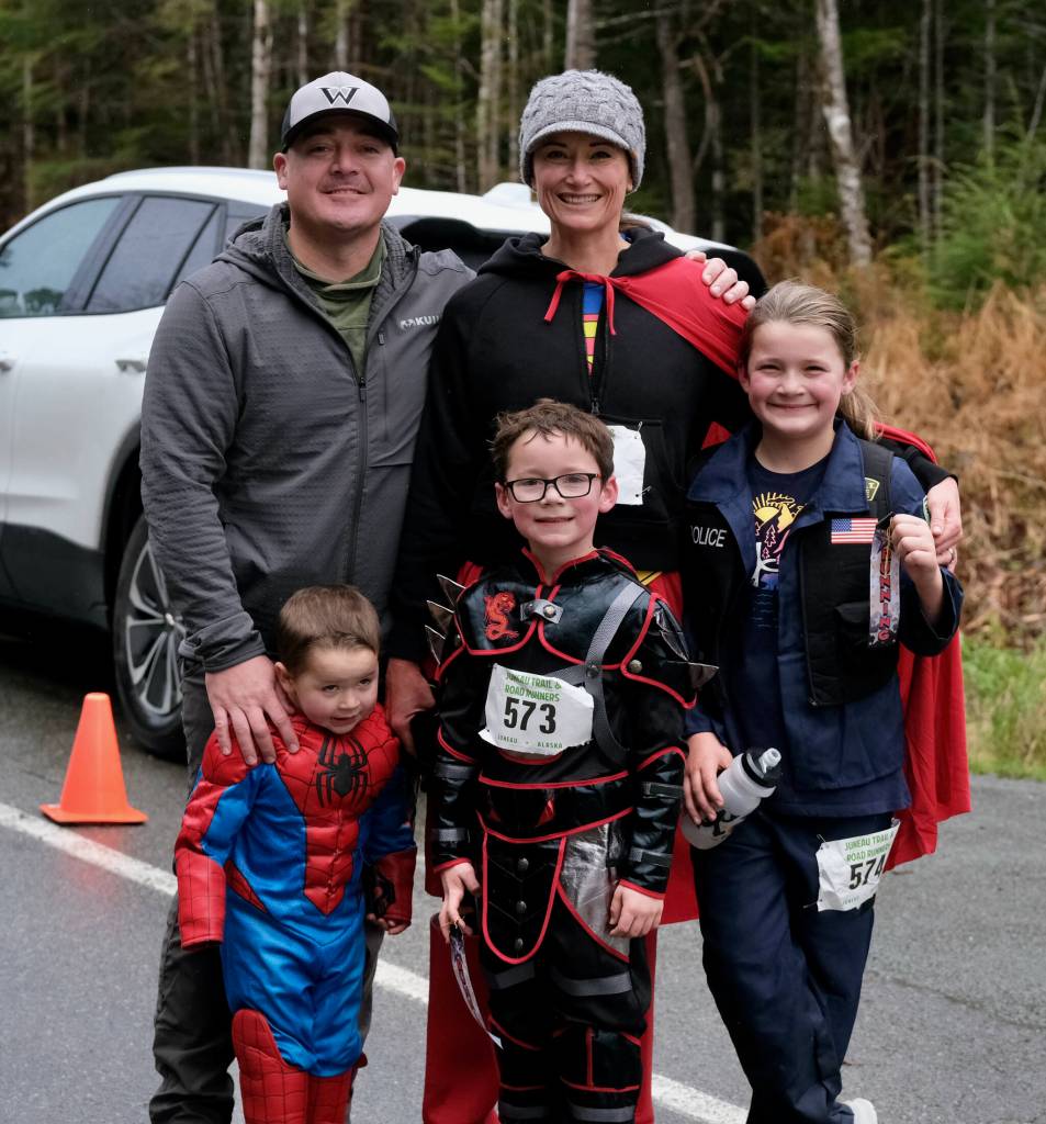 Joe Just Dad Anthony and Superwoman Shannon Anthony with their children Billie as Spiderman, James as a Ninja and Ava as a S.W.A.T. member during the Halloween Half Marathon and 5K on Saturday along North Douglas Highway. (Klas Stolpe / Juneau Empire)