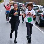 Jessica Geary and Amanda Kohan finish the Halloween Half Marathon and 5K on Saturday along North Douglas Highway. (Klas Stolpe / Juneau Empire)
