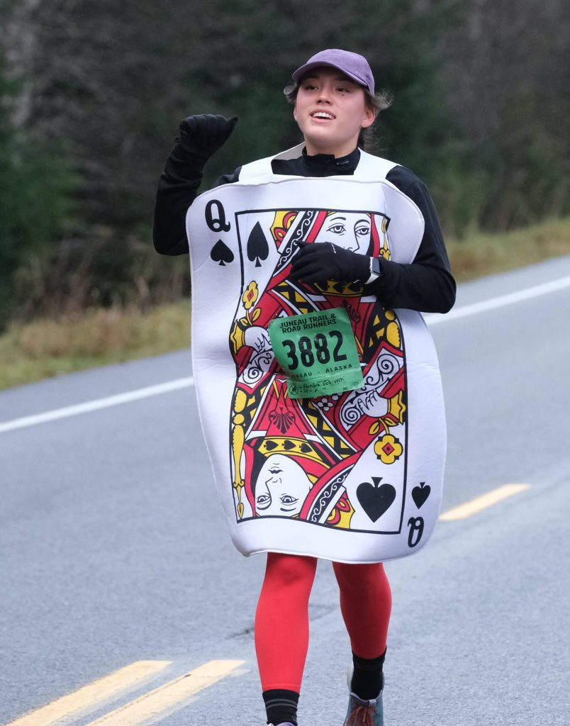 Alondra Echiverri finishes the Halloween Half Marathon and 5K on Saturday along North Douglas Highway. (Klas Stolpe / Juneau Empire)