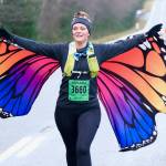 Naomi Watkins finishes the Halloween Half Marathon and 5K on Saturday along North Douglas Highway. (Klas Stolpe / Juneau Empire)