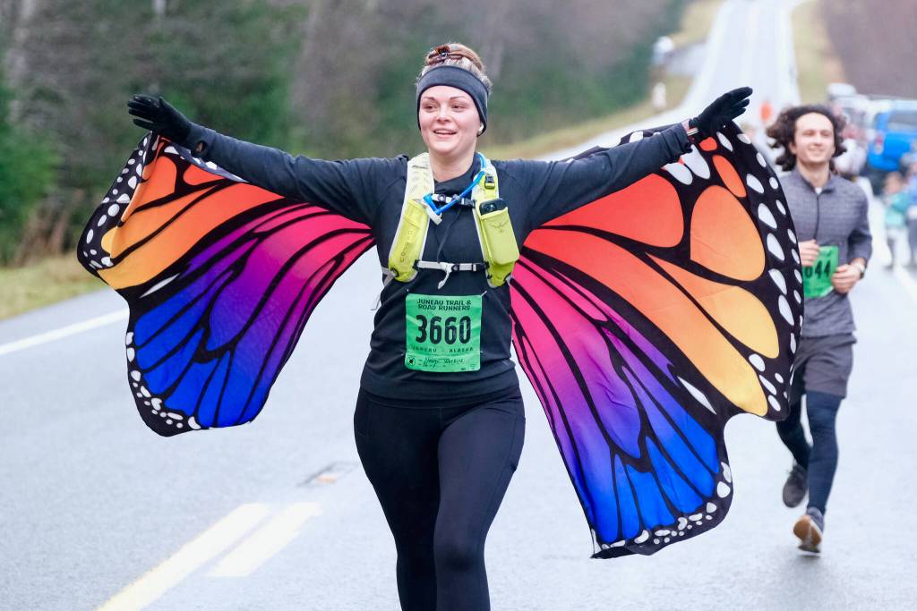 Naomi Watkins finishes the Halloween Half Marathon and 5K on Saturday along North Douglas Highway. (Klas Stolpe / Juneau Empire)
