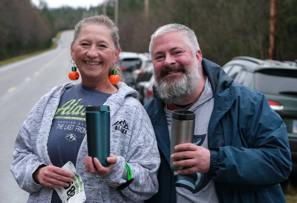 Kim McDowell sports pumpkin earrings and Josh Applebee Halloween spirit during the 5K race at Saturdays Halloween Half Marathon and 5K on North Douglas Highway. (Klas Stolpe / Juneau Empire)