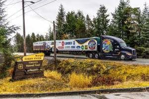 A truck carries the 2024 U.S. Capitol Christmas Tree from a forest in Wrangell to the towns Alaska Marine High Ferry Terminal in preparation for the trees journey to Washington, D.C. (James Edward Mills / U.S. Forest Service)