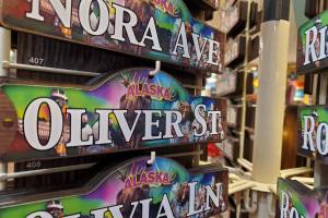 Alaska souvenir name signs are seen on Monday at a gift shop in the Ted Stevens Anchorage International Airport. Oliver was the most popular name for baby boys born in Alaska in 2023, according to the states annual vital statistics report. Nora was tied as the fourth-most-popular among the names for baby girls, according to the report. (Yereth Rosen/Alaska Beacon)