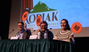 From left to right, Nick Begich, Republican candidate for U.S. House; Alaskan Independence Party candidate John Wayne Howe and Rep. Mary Peltola, D-Alaska, hold up paddles indicating their opposition to finfish farming in Alaska. Howe and imprisoned out-of-state Democrat Eric Hafner are receiving attention from the leading campaigns. (James Brooks/Alaska Beacon)
