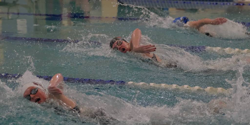 Juneau-Douglas High School: Yadaa.at Kalé sophomore Bailey Fisher, center, swims the girls 50 yard freestyle during the 2024 Region V Swim & Dive Championships Saturday at the Petersburg Aquatic Center. (Klas Stolpe / Juneau Empire)