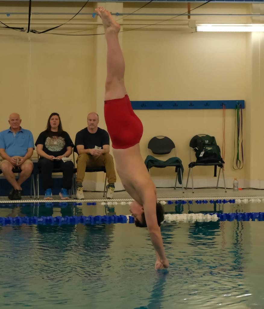 Juneau-Douglas High School: Yadaa.at Kalé sophomore Easton Berger dives during the 2024 Region V Swim & Dive Championships Saturday at the Petersburg Aquatic Center. (Klas Stolpe / Juneau Empire)