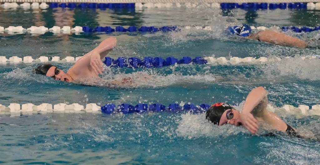 Juneau-Douglas High School: Yadaa.at Kalé junior Deedee Mills leads sophomore teammate Bailey Fisher and Petersburgs Brooklyn Whitethorn during the 2024 Region V Swim & Dive Championships Saturday at the Petersburg Aquatic Center. (Klas Stolpe / Juneau Empire)