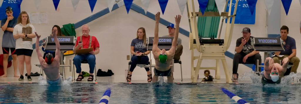 Juneau-Douglas High School: Yadaa.at Kalés Liam Kiessling, Craigs Grant Maygren and Ketchikans Easton Yoder start the boys 100 backstroke during the 2024 Region V Swim & Dive Championships Saturday at the Petersburg Aquatic Center. (Klas Stolpe / Juneau Empire)