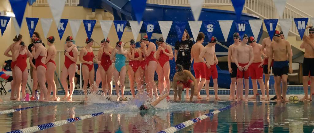 The Juneau-Douglas High School: Yadaa.at Kalé Crimson Bears warm up Friday during the 2024 Region V Swim & Dive Championships at the Petersburg Aquatic Center pool. (Klas Stolpe / Juneau Empire)