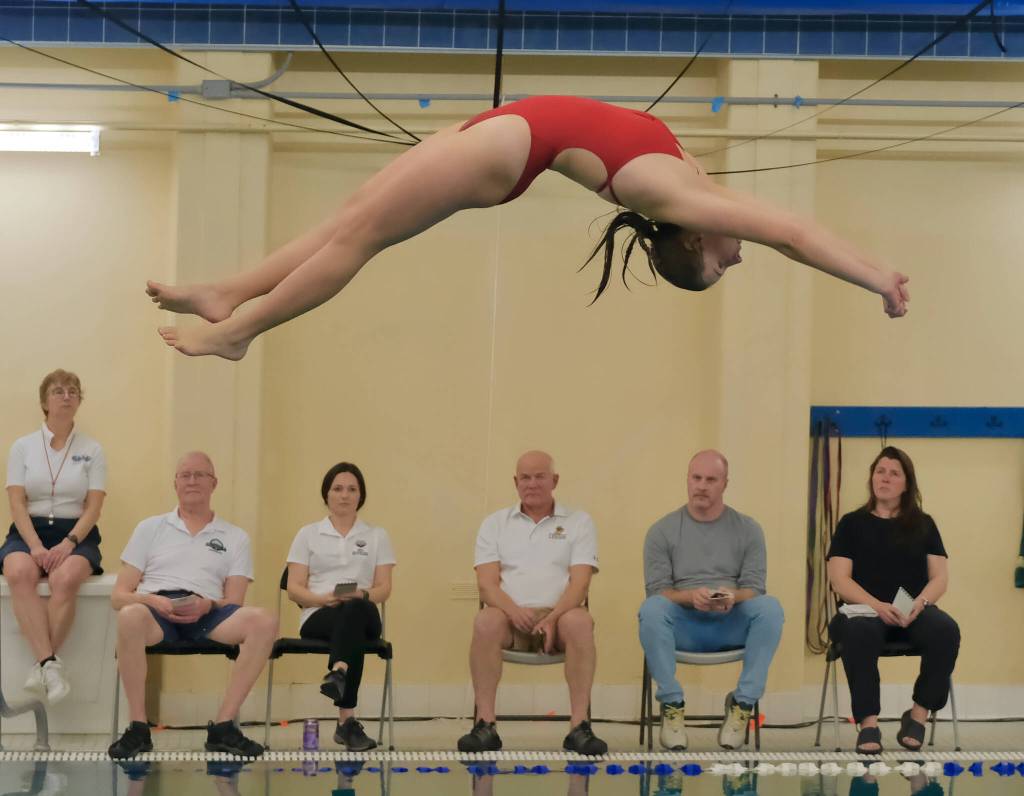 Juneau-Douglas High School: Yadaa.at Kalé sophomore Adeline Williams dives Friday during the 2024 Region V Swim & Dive Championships at the Petersburg Aquatic Center pool. (Klas Stolpe / Juneau Empire)