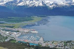 A docked cruise ship, the Regent Seven Seas Explorer, is seen in Sewards harbor on June 19 from the Race Point on Mount Marathon. The Port of Seward received a Clean Ports Program grant from the Environmental Protection Agency for a shore-based system to power cruise ships when they are docked in town. (Yereth Rosen/Alaska Beacon)