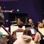 William Todd Hunt guides the Taku Winds ensemble through a rehearsal of music by Indigenous composers on Tuesday evening at Thunder Mountain Middle School. (Mark Sabbatini / Juneau Empire)