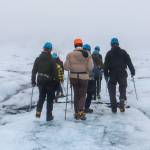 Attendees from the Arctic Circle Assembly hike on Sólheimajökull glacier on Oct. 20. (Jasz Garrett / For the Juneau Empire)
