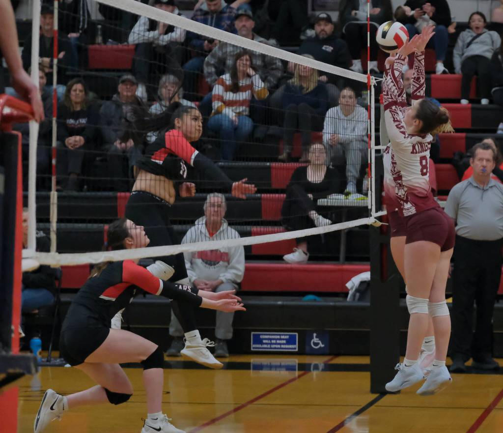 Juneau-Douglas High School: Yadaa.at Kalé junior Lavinia Maake (11) kills a shot against Ketchikan juniors Payton Hagan and Addisen Zink (8) during the Crimson Bears 20-25, 25-9, 25-11, 25-18 match win Friday during the Region V Volleyball Championships at Juneaus George Houston Gymnasium. (Klas Stolpe / Juneau Empire)