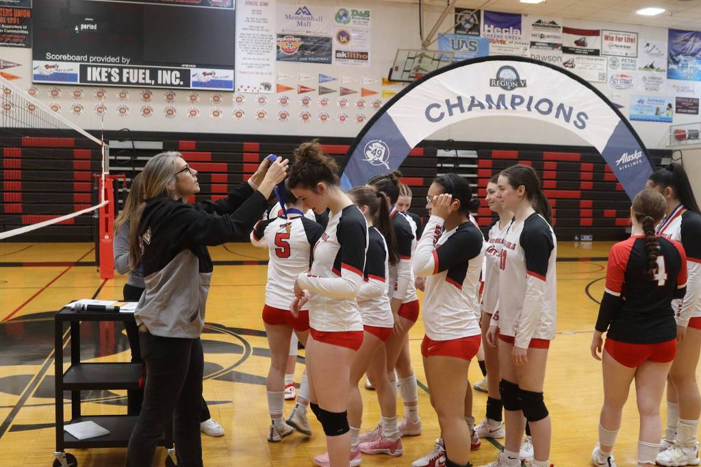 Juneau-Douglas High School: Yadaa.at Kalé volleyball players get their Region V championship medals from JDHS Athletic Director Julie Herman. Herman coached the volleyball team for Thunder Mountain High School which won three straight conference titles during the past three years until the students were consolidated into JDHS this year. (Mark Sabbatini / Juneau Empire)