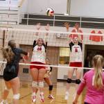 Juneau-Douglas High School: Yadaa.at Kalés Natalia Harris (20) and Evelyn Richards (8) try to block a shot during Saturdaya game against Ketchikan High School at JDHS. (Mark Sabbatini / Juneau Empire)