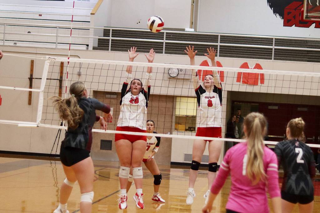 Juneau-Douglas High School: Yadaa.at Kalés Natalia Harris (20) and Evelyn Richards (8) try to block a shot during Saturdaya game against Ketchikan High School at JDHS. (Mark Sabbatini / Juneau Empire)