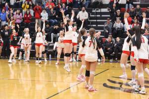 The Juneau-Douglas High School: Yadaa.at Kalé volleyball team celebrates scoring the winning point in Saturdays game against Ketchikan High School at JDHS to win the Region V title and advance to the state tournament next week. (Mark Sabbatini / Juneau Empire)