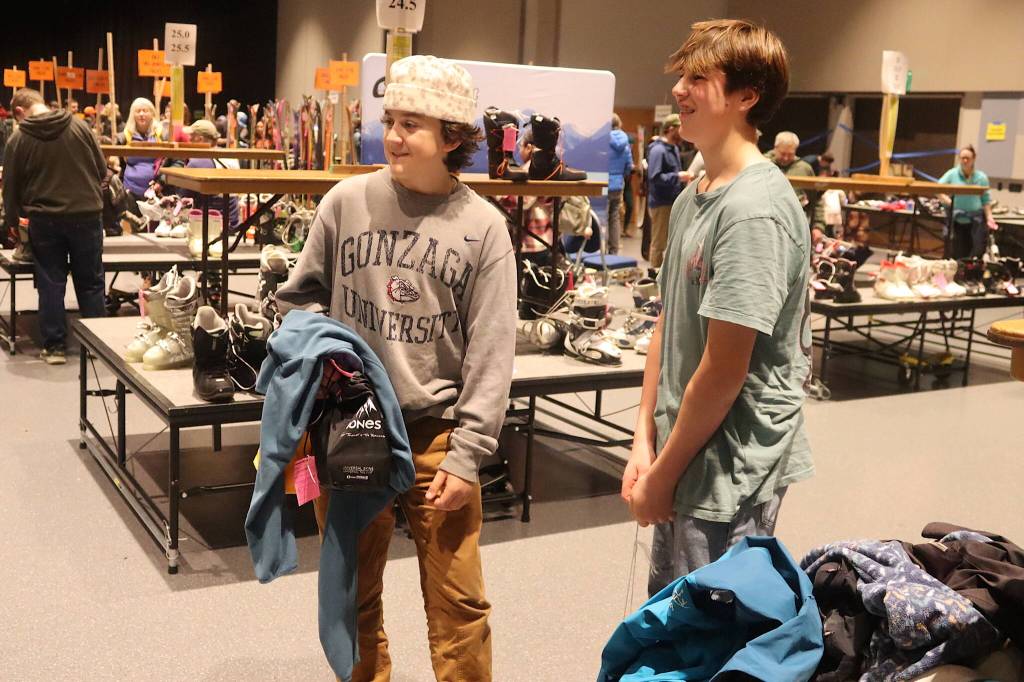 Bay White, 14, and Henry Maier, 13, examine the length of the checkout line during the annual Juneau Ski Sale at Centennial Hall on Saturday. The teens say they were the first in line at the event, showing up sometime between 6 and 6:30 a.m., with the doors to the sale opening at 10 a.m. (Mark Sabbatini / Juneau Empire)