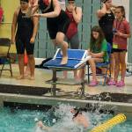 Juneau-Douglas High School: Yadaa.at Kalé senior Pacific Ricke leaves the starting block as sophomore Bailey Fisher touches in the girls 200 freestyle relay final during the ASAA Swim & Dive State Championships on Saturday at Anchorages Bartlett High School pool. (Klas Stolpe / Juneau Empire)
