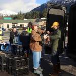 Juneau Assembly Member Ella Adkison (center) helps state Sen. Jesse Kiehl load donated groceries into a van on Saturday during a food drive at Super Bear IGA Supermarket hosted by the Juneau Central Labor Council. (Mark Sabbatini / Juneau Empire)