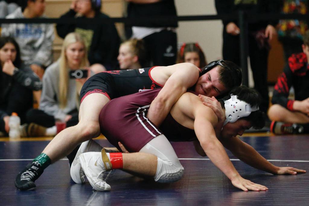 Juneau Douglass Ethan Van Kirk controls the back of Ketchikans Cayden Harney. Van Kirk won the match by pinning Harney during the Bill Weiss Wrestling Tournament at the Clarke Cochrane Gymnasium at Ketchikan High School on Friday. (Christopher Mullen / Ketchikan Daily News)