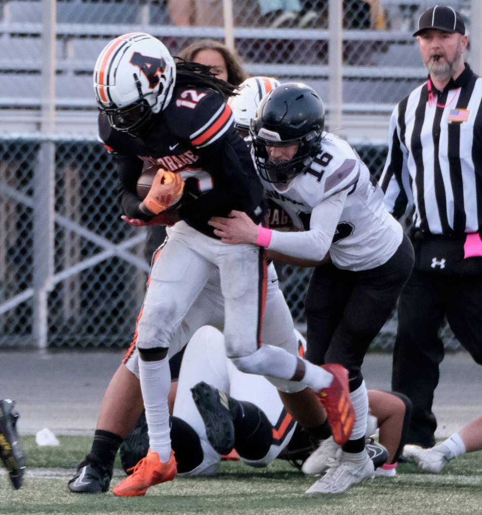 Juneau senior Caleb Ziegenfuss (16) tackles West Anchorage junior Talon Copeland (12) during the state playoffs at West Anchorage. Ziegenfuss was selected an All-State outside linebacker. (Klas Stolpe / Juneau Empire file photo)