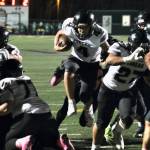 Juneau Huskies senior Jayden Johnson (4) finds a hole to run through against the Colony Knights in Palmer this season. (Klas Stolpe / Juneau Empire file photo)