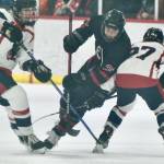 Juneau-Douglas High School: Yadaa.at Kalé junior Elliot Welch (36) works for a puck between North Pole senior Dylan Earl (55) and junior Carter Borkovec (27) during the Crimson Bears 4-2 loss to the Patriots on Friday at the Treadwell Ice Arena. The two teams play again Saturday at 3 p.m. (Klas Stolpe / Juneau Empire)