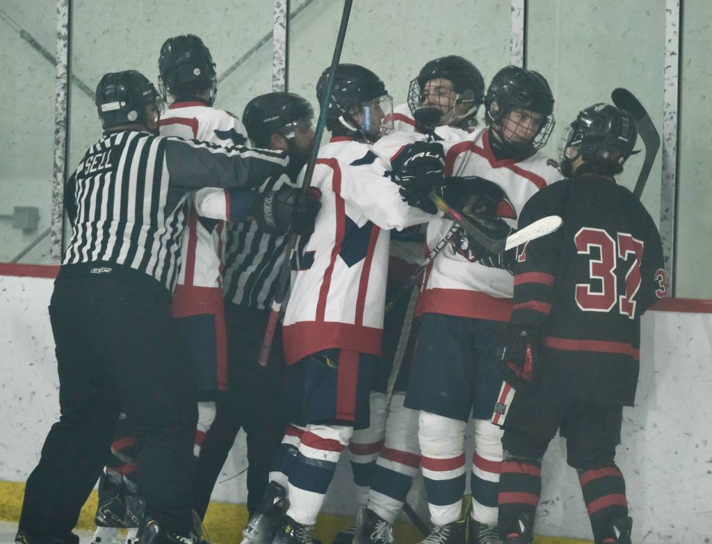 Referees break up a hockey melee during the Crimson Bears 5-2 loss to the Patriots on Saturday at the Treadwell Ice Arena. (Klas Stolpe / Juneau Empire)