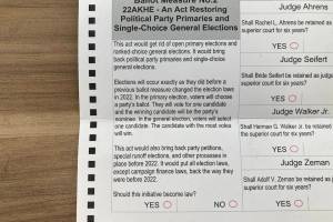The language of Ballot Measure 2 appears on Alaskas 2024 absentee ballots. The measure would repeal the states open primary and ranked choice voting system. (Andrew Kitchenman/Alaska Beacon)
