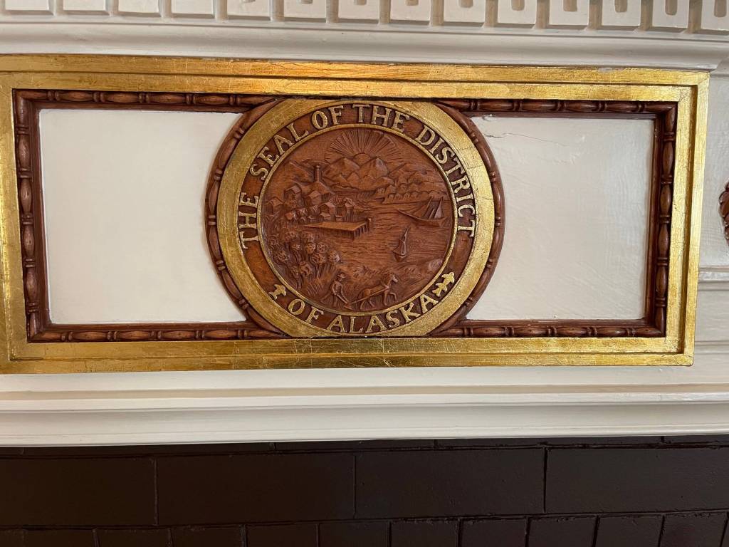 The original seal of the District of Alaska has a place of honor affixed to the mantle of the ballroom fireplace. (Laurie Craig / Juneau Empire)