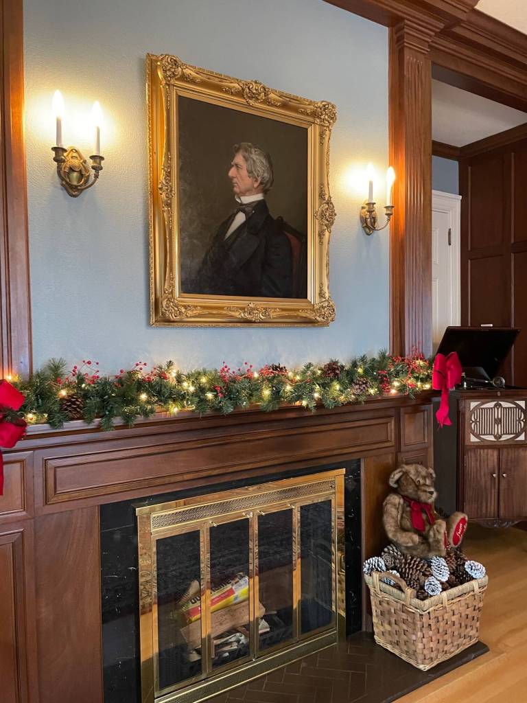 Portrait of then-Secretary of State William H. Seward, who brokered the transfer of Alaska from Russia to America in 1867, is displayed in the house library with holiday decorations adding a festive touch. (Laurie Craig / Juneau Empire)