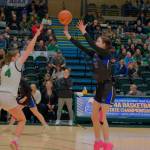 Current senior Kerra Baxter (22) shoots a three point shot for now defunct Thunder Mountain High School in last seasons ASAA state championship semifinal against the Colony Knights Jericho Wiestemberg (4). Baxter has signed to play Division II college basketball with the University of Alaska Anchorage Seawolves. She will play for Juneau-Douglas High School: Yadaa.at Kalé this year. (Klas Stolpe / Juneau Empire) 3