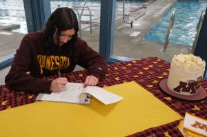 Juneau-Douglas High School: Yadaa.at Kalé senior Emma Fellman signs a national letter of intent on Thursday at Augustus Brown Pool to attend and swim for the University of Minnesota. (Klas Stolpe / Juneau Empire)