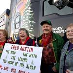 Terri Teese Austin Winbolt, center left, holds a sign she made for her brother, Fred Austin, center right Monday as they stand near the truck he was driving that was carrying the National Christmas Tree at its stop in Loveland. Their sisters, Mary Austin Zawloki, left, and Tina Austin Hickey, right, also visit with their brother during an event to welcome the tree to Loveland at The Ranch. (Jenny Sparks/Loveland Reporter-Herald)
