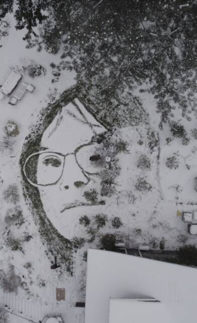An depiction of artist Blake Byers girlfriend, Alyssa James, is seen on a grass surface covered with snow in Oregon. Byers says he created the image using a garden sprayer. (Photo by Blake Byers)