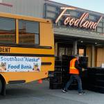 A volunteer unloads empty crates in front of Foodland IGA on Saturday morning in preparation for the Southeast Alaska Food Banks annual Caring is Sharing Food Drive. (Mark Sabbatini / Juneau Empire)