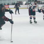 Juneau-Douglas High School: Yadaa.at Kalé senior Dylan Sowa (35) shoots a puck against North Pole in action earlier this season at Treadwell Ice Arena. Sowa had two goals against the Palmer Moose Saturday at Palmer. (Klas Stolpe / Juneau Empire file photo)