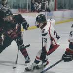 Juneau-Douglas High School: Yadaa.at Kalé junior Isaac Phelps (24) shoots a puck against North Pole in action earlier this season at Treadwell Ice Arena. Phelps had two assists against the Palmer Moose this weekend at Palmer. (Klas Stolpe / Juneau Empire file photo)