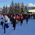 Austin Treston (wearing Santa hat) and Oliver Albrecht, both 11, lead off participants in the mile-long course during the annual Turkey Trot 5K and 1 Mile Fun Run on Thursday along the Airport Dike Trail. (Mark Sabbatini / Juneau Empire)