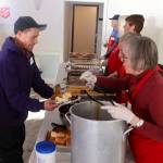 Volunteers prepare traditional Thanksgiving Day meal plates during a communal meal Thursday at the Juneau Yacht Club. (Mark Sabbatini / Juneau Empire)