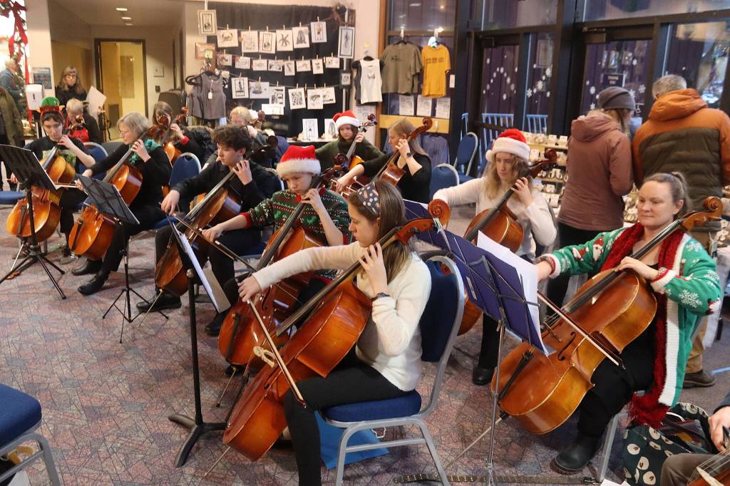 A cello group performs holiday songs in the main lobby of Centennial Hall during the Juneau Public Market on Friday. (Mark Sabbatini / Juneau Empire)