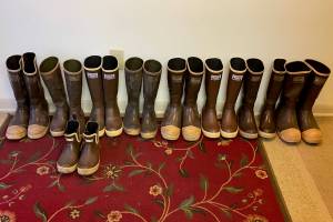 Nine pairs of rubber boots await feet near the entrance to Catherine Fritzs home in Juneau. The collection includes very early models made in the United States, later imported versions that are steel-toed, insulated and regular. Fritzs favorite pair is a short version that slip on easily. (Laurie Craig / Juneau Empire)